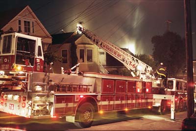 A house burns in Noe Valley, San Francisco. The fire department shows up, people watch.