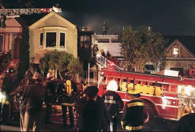 A house burns in Noe Valley, San Francisco. The fire department shows up, people watch.