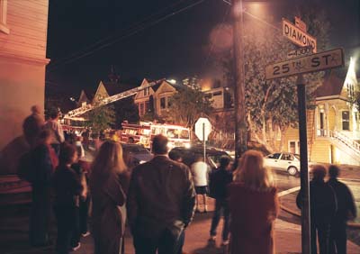 A house burns in Noe Valley, San Francisco. The fire department shows up, people watch.